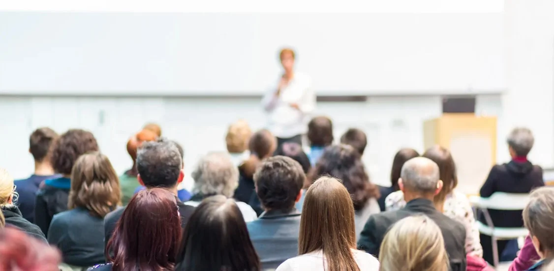 Photo of speaker and audience