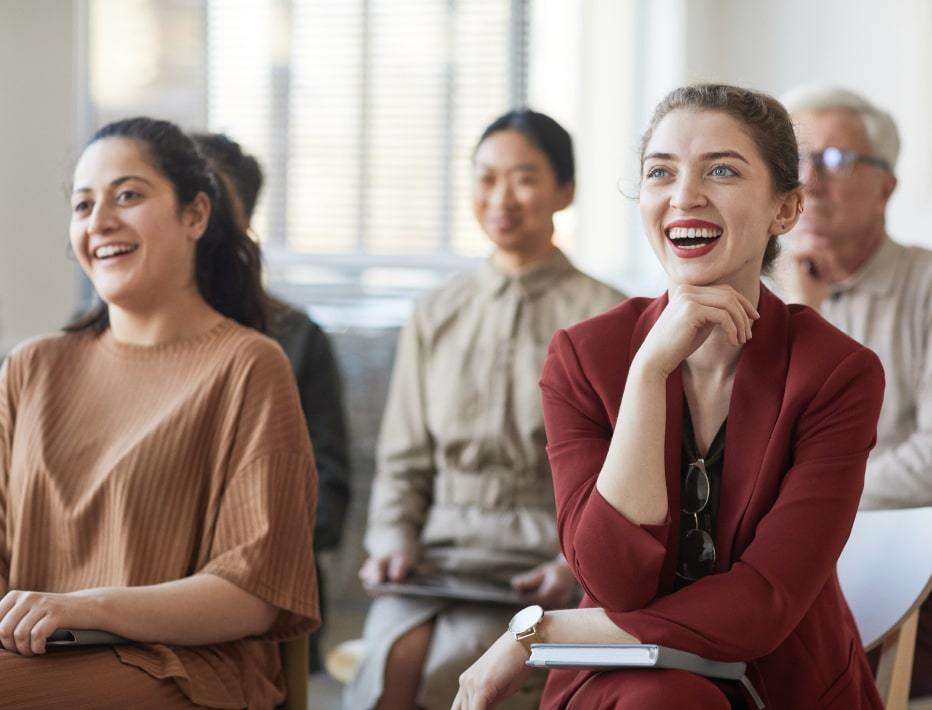 Audience of business people smiling